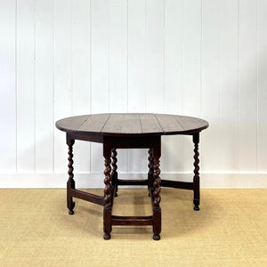 An Antique English Country Barley Twist Oak Drop Leaf Gate Leg Table