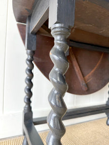 An Antique English Ebonized Country Oak Drop Leaf Gate Leg Table