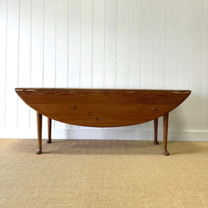 An Antique Irish Pine Oval Drop Leaf Kitchen Dining Table with Spoon Feet