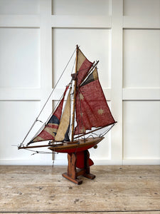 An English Antique Red Pond Yacht with Stand