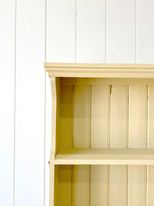 An Antique English Bookcase in Butter Yellow