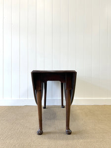 An Antique Mahogany Drop Leaf Dining Table with Pad Feet