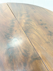 An Antique Mahogany Drop Leaf Dining Table with Pad Feet