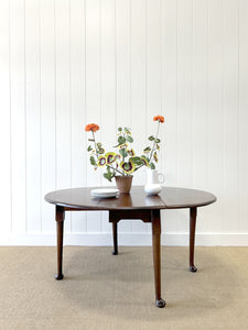 An Antique Mahogany Drop Leaf Dining Table with Pad Feet