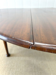 An Antique Mahogany Drop Leaf Dining Table with Pad Feet