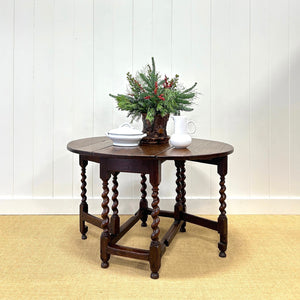 An Antique English Country Barley Twist Oak Drop Leaf Gate Leg Table