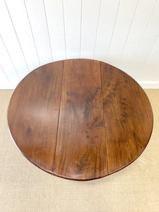 An Antique Mahogany Drop Leaf Dining Table with Pad Feet