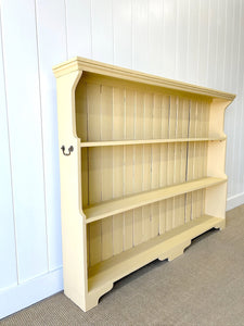 An Antique English Bookcase in Butter Yellow