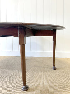 An Antique Mahogany Drop Leaf Dining Table with Pad Feet