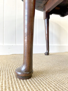An Antique Mahogany Drop Leaf Dining Table with Pad Feet