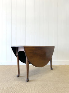 An Antique Mahogany Drop Leaf Dining Table with Pad Feet