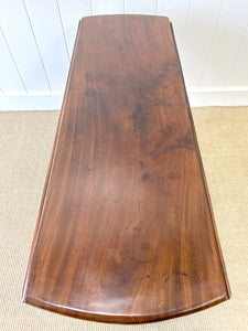 An Antique Mahogany Drop Leaf Dining Table with Pad Feet