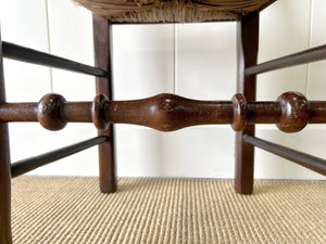 A Vintage Set of 6 English Oak Spindle Back Chairs with Rush Seats