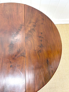 An Antique Mahogany Drop Leaf Dining Table with Pad Feet