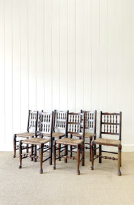 A Vintage Set of 6 English Oak Spindle Back Chairs with Rush Seats