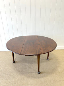 An Antique Mahogany Drop Leaf Dining Table with Pad Feet