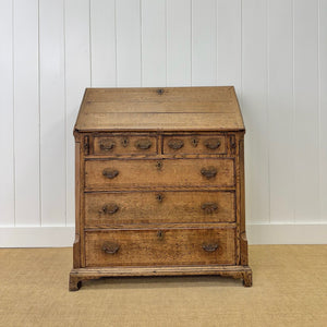 An Antique English Georgian Cumbrian Washed Oak Slant Front Desk