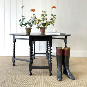 An Antique English Ebonized Country Oak Drop Leaf Gate Leg Table
