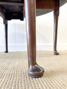 An Antique Mahogany Drop Leaf Dining Table with Pad Feet