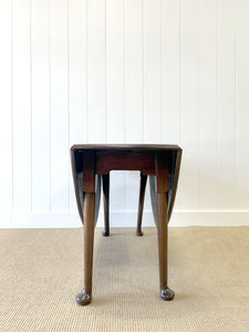 An Antique Mahogany Drop Leaf Dining Table with Pad Feet