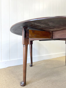 An Antique Mahogany Drop Leaf Dining Table with Pad Feet