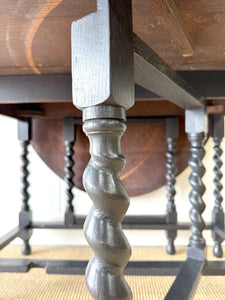 An Antique English Ebonized Country Oak Drop Leaf Gate Leg Table