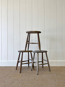 A Set of 3 Elm Splayed Leg Stools