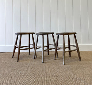 A Set of 3 Elm Splayed Leg Stools
