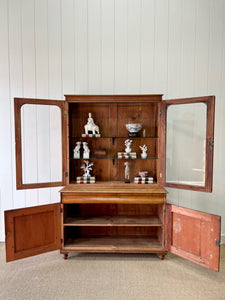A 19th Century English Pine Bookcase with Glazed Top Doors