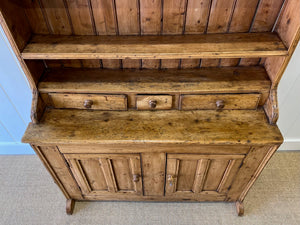 An Early 19th Century Pine Irish Dresser or Cupboard with Wooden Knobs