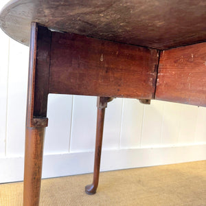 An Antique 18th Century Drop Leaf Dining Table with Pad Feet