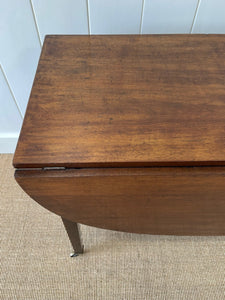 A Large English Georgian Country Mahogany Drop Leaf Table on Castors c1800