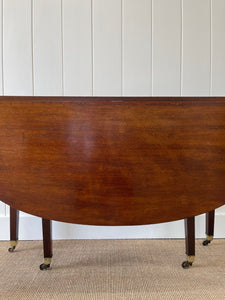 A Large English Georgian Country Mahogany Drop Leaf Table on Castors c1800