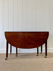 A Large English Georgian Country Mahogany Drop Leaf Table on Castors c1800