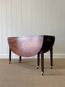 A Large English Georgian Country Mahogany Drop Leaf Table on Castors c1800