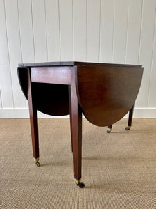A Large English Georgian Country Mahogany Drop Leaf Table on Castors c1800