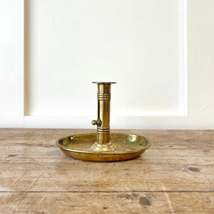 An Antique English Brass Chamber Stick