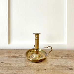 An Antique English Brass Chamber Stick