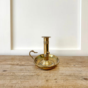 An Antique English Brass Chamber Stick