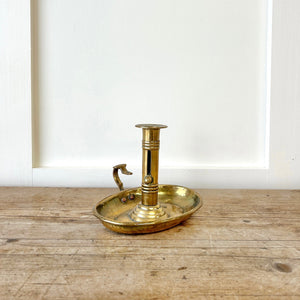 An Antique English Brass Chamber Stick