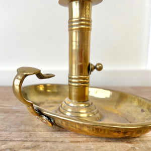An Antique English Brass Chamber Stick