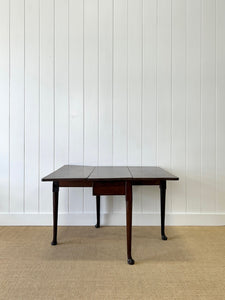 An Antique 18th Century Drop Leaf Dining Table with Pad Feet