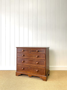 A English George III Oak Country Built Feather-banded Chest of Drawers