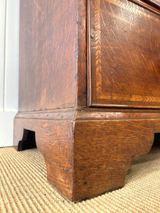 A English George III Oak Country Built Feather-banded Chest of Drawers