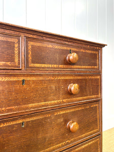 A English George III Oak Country Built Feather-banded Chest of Drawers