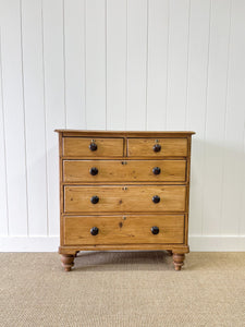 An Antique English Pine Chest of Drawers Dresser with Dark Wooden Knobs