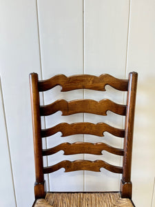 A Vintage Set of 8 English Oak Ladder Back Chairs with 2 Captain's Chairs