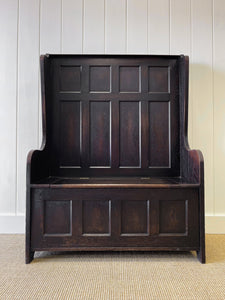 An Antique English Oak Settle with Seat Storage
