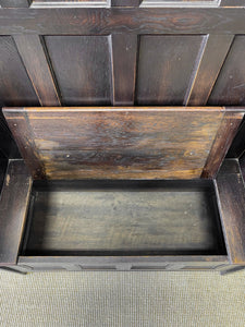 An Antique English Oak Settle with Seat Storage