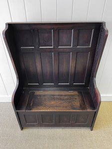An Antique English Oak Settle with Seat Storage